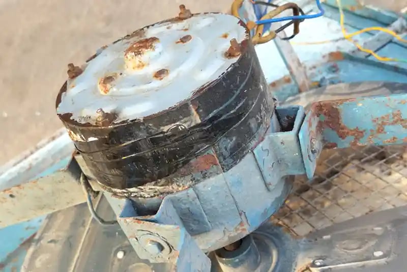 Rusty and damaged motor of an evaporative cooler