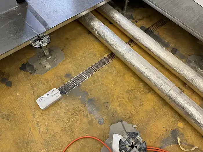Image of smart leak detectors used for completing a leak check on pipes in a commercial environment Image of smart leak detectors used for completing a leak check on pipes in a commercial environment